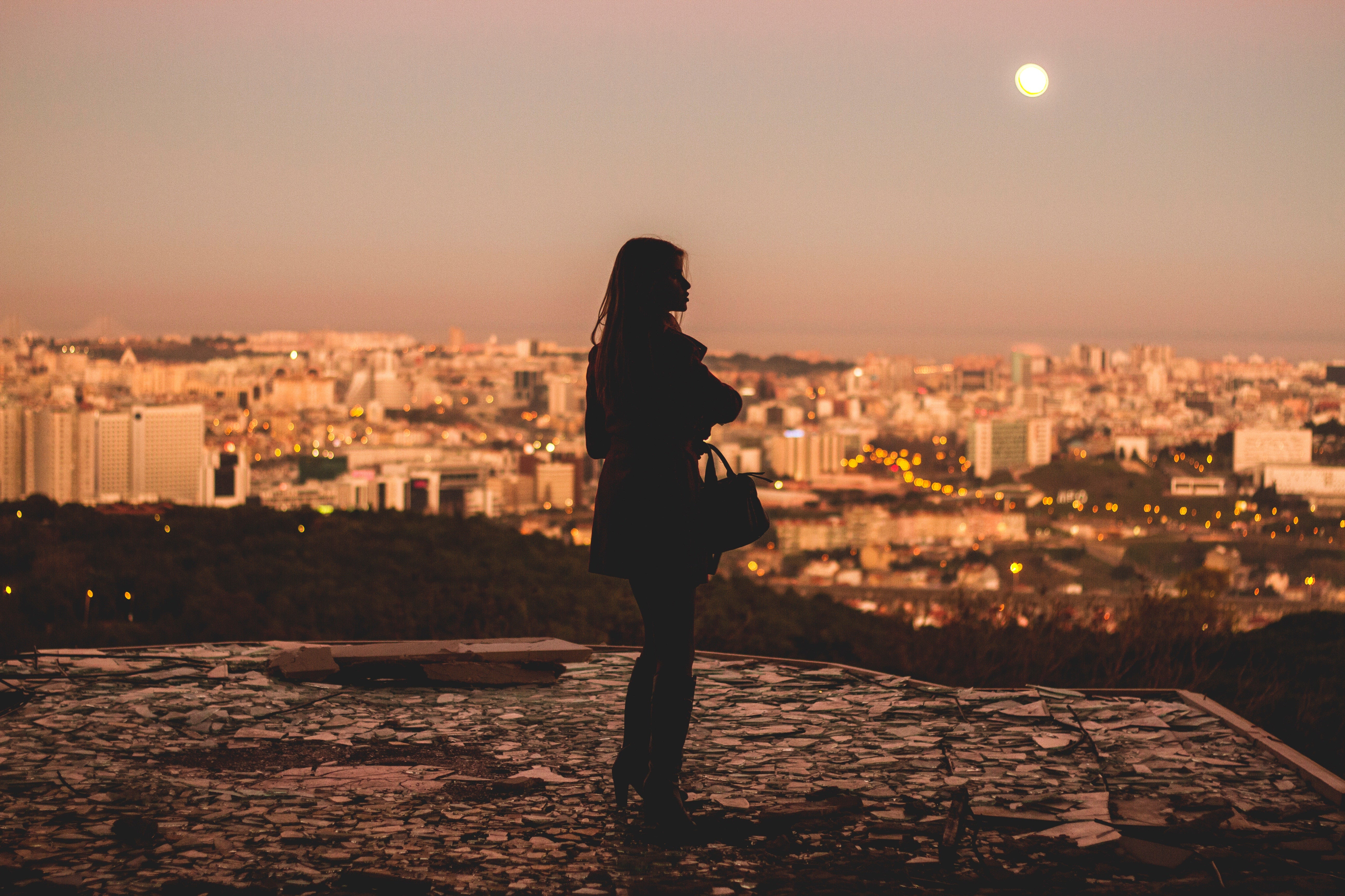 A woman looking out over the beautiful city of Lisbon as the sun sets